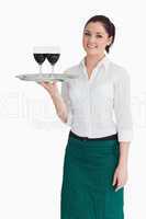 Woman holding tray with glasses of wine