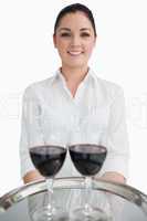 Waitress holding tray with glasses of wine