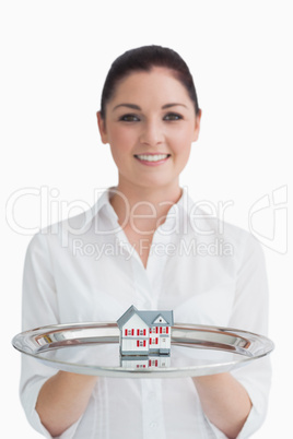 Waitress holding a little house