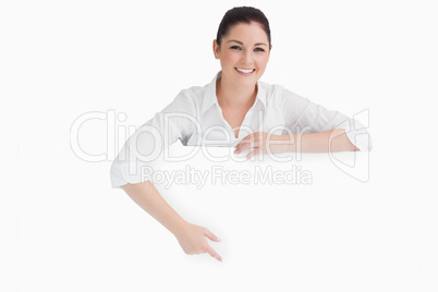 Woman pointing to white board