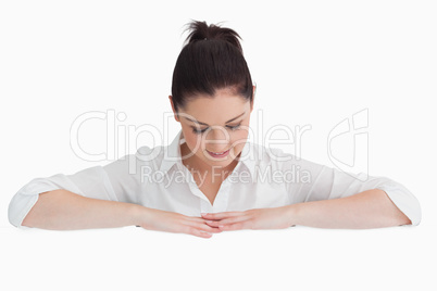 Woman leaning on arms and looking down