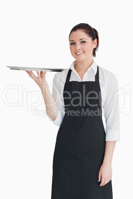 Smiling woman holding an empty silver tray