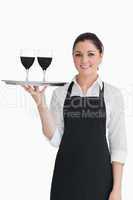 Pretty waitress holding two glasses of wine