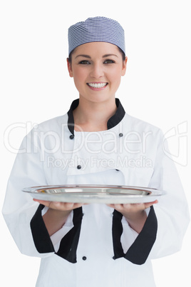 Cook holding a silver tray