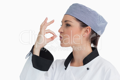 Chef making sign for tasty with her hands