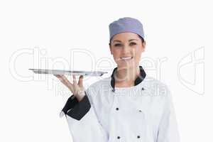 Chef holding an empty silver tray