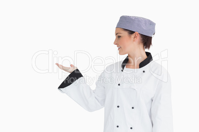 Chef holding hand out to left