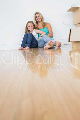 Mother and daughter sitting on the floor together