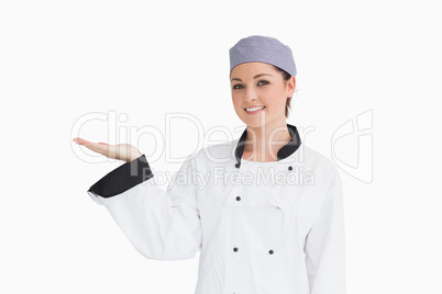 Chef holding out hand in presentation