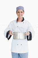 Cook holding a pot