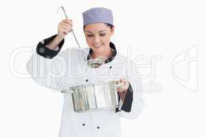 Happy cook with a ladle and a pot