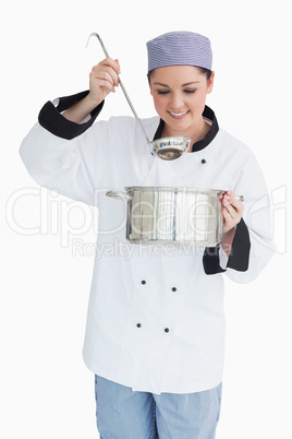 Smiling chef with pot and ladle