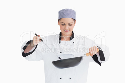 Cook cooking with wok and spoon
