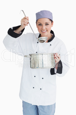 Glad cook serving with a ladle and a pot