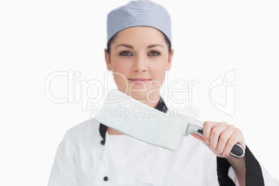 Smiling cook holding a meat cleaver