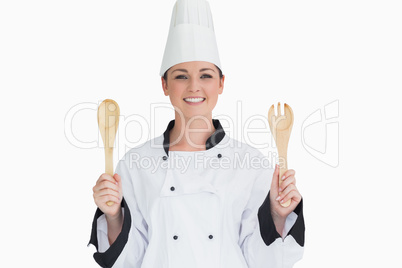 Cook holding wooden salad tosses