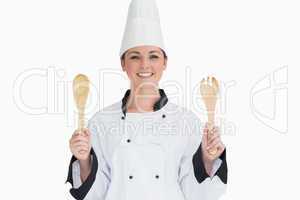Cook holding wooden salad tosses
