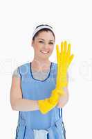 Maid putting on yellow gloves