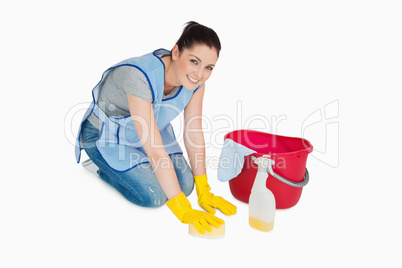 Smiling cleaning woman washing the floor