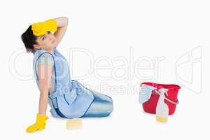 Exhausted woman cleaning the floor