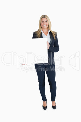 Smiling businesswoman holding a white panel