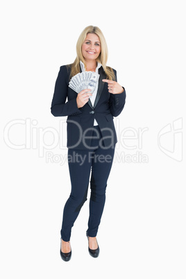 Smiling Well-dressed woman holding dollars