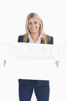 Happy business woman showing a white panel