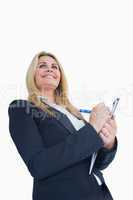 Smiling business woman writing in the clipboard