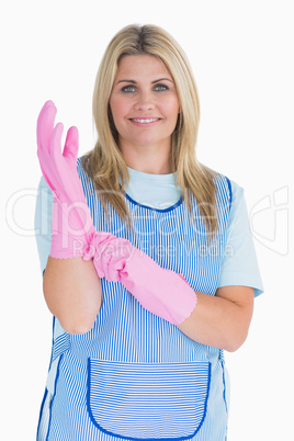 Cleaner woman putting pink gloves on