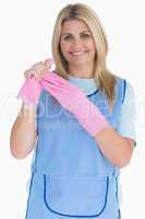 Cleaner woman removing pink gloves