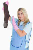 Cleaning woman holding a dirty sock