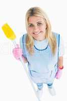 Happy cleaner woman holding a broom