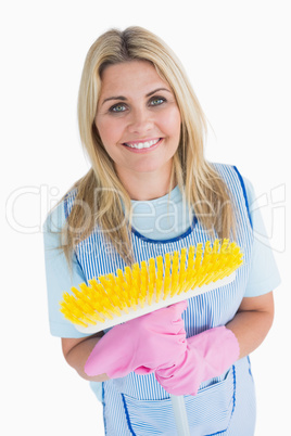Cleaner woman holding a yellow broom