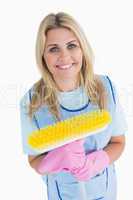 Cleaner woman holding a yellow broom