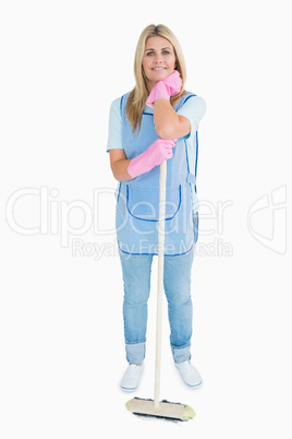 Smiling cleaner woman holding a broom