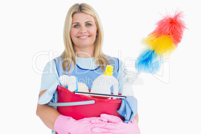 Cleaner woman holding a pink bucket with cleaning supplies