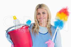 Smiling cleaner woman holding a bucket and feather duster