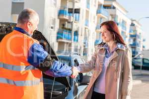 Woman greeting mechanic after her car breakdown