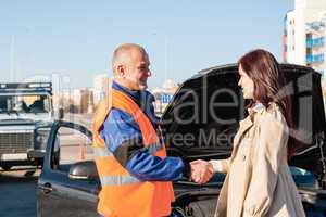 Woman greeting mechanic after her car breakdown