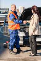 Woman greeting mechanic after her car breakdown