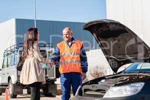 Woman shaking hands with mechanic car breakdown