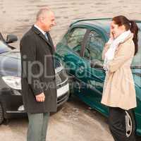 Man and woman talking after car crash