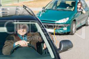 Man helping woman by pulling her car