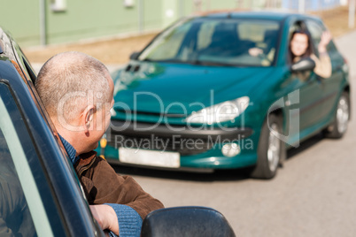 Man pulling a woman's car with problems