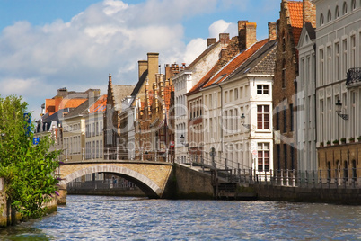 Facade of flemish houses and canal in Brugge