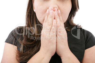 A young woman praying with her hands together on white backgroun