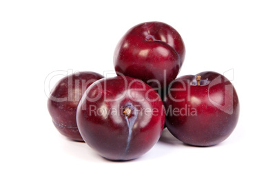 Group of plums  on white