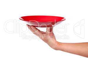 Red kitchen plate on a hand isolated