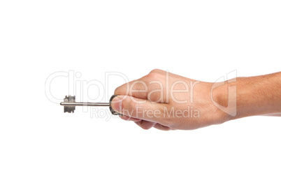 Male hand holding a key to the house