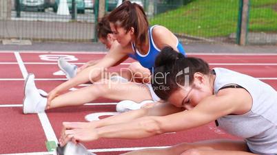 Women stretching on a track